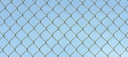 Chain Link Fence With Blue Background
